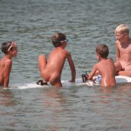 Several Kids On Surfboard